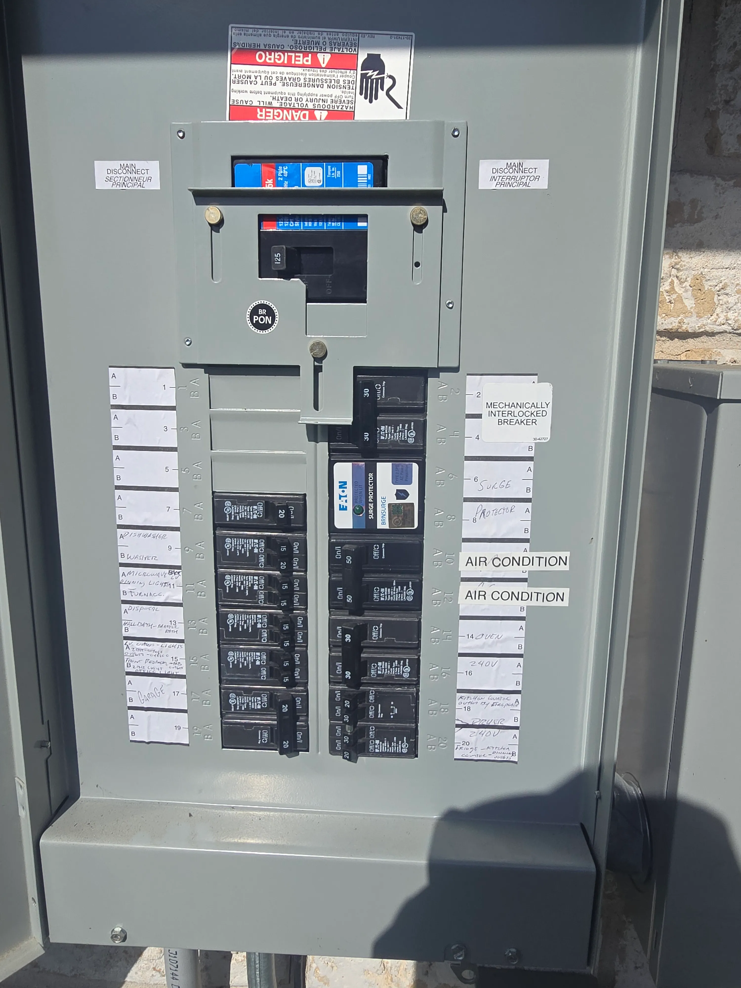 Interior of an electrical panel with organized breakers and wiring.