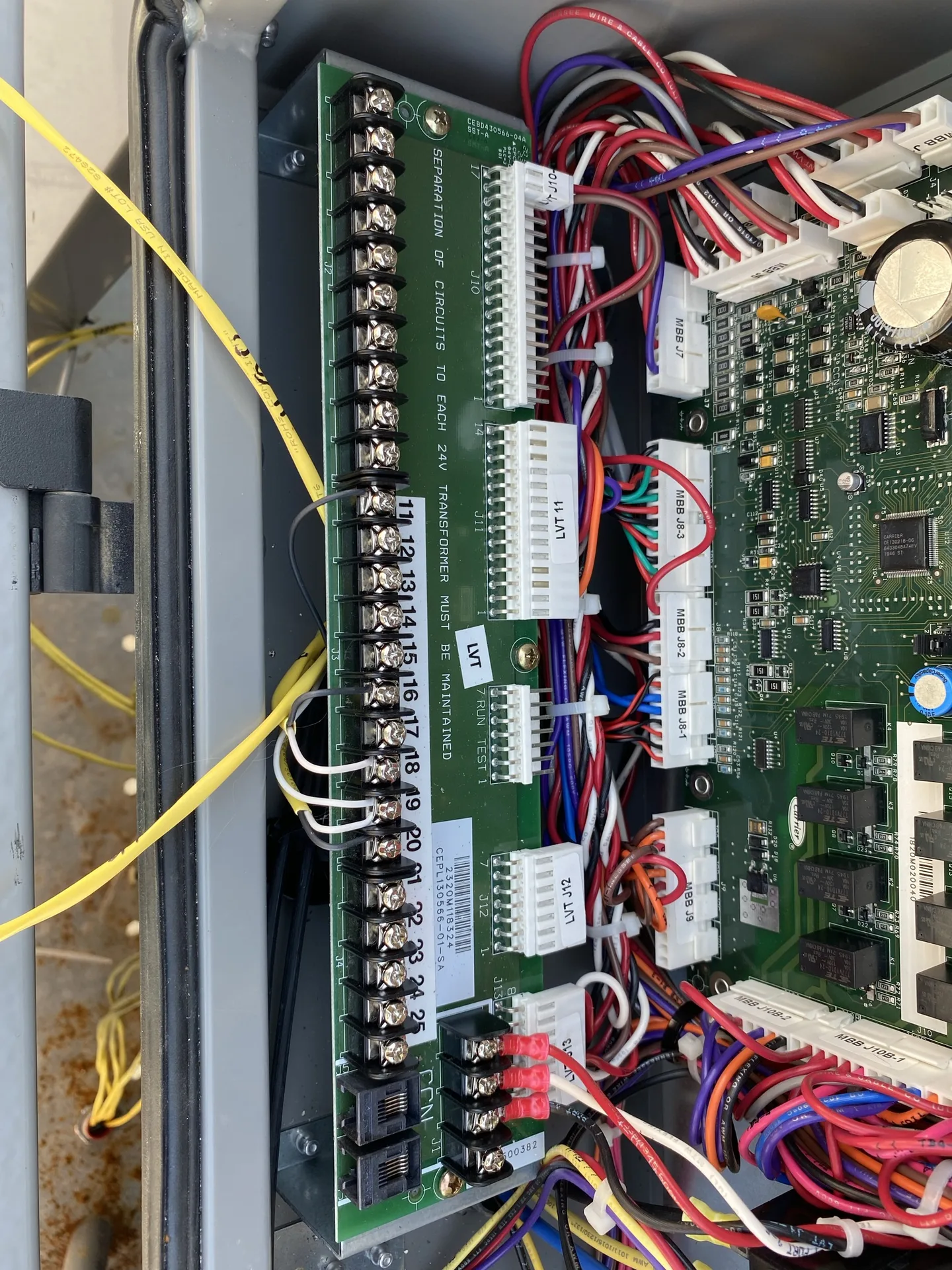 Datacom or low-voltage control panel with organized cable routing.