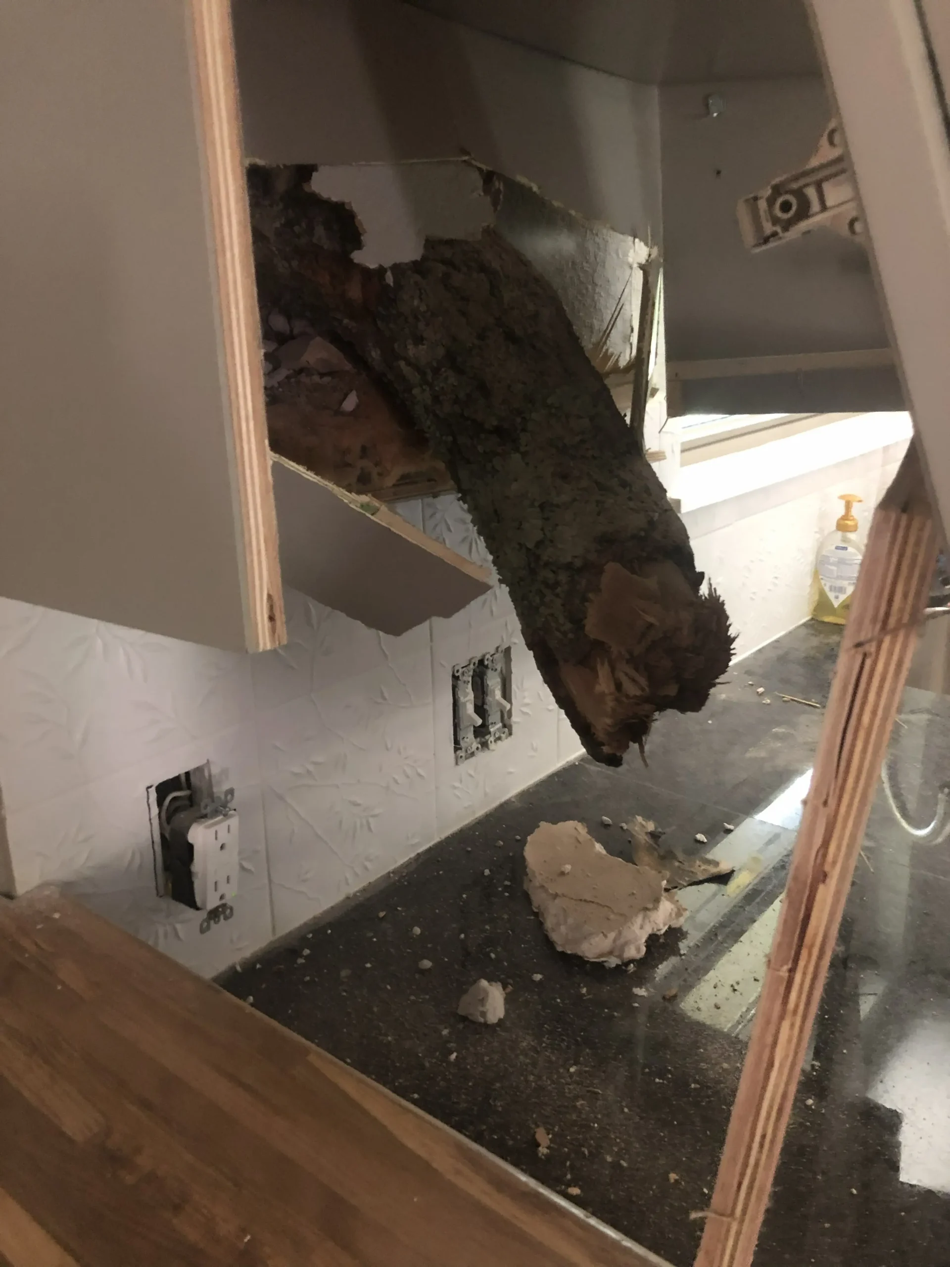 Interior storm damage near outlets and exposed electrical wiring