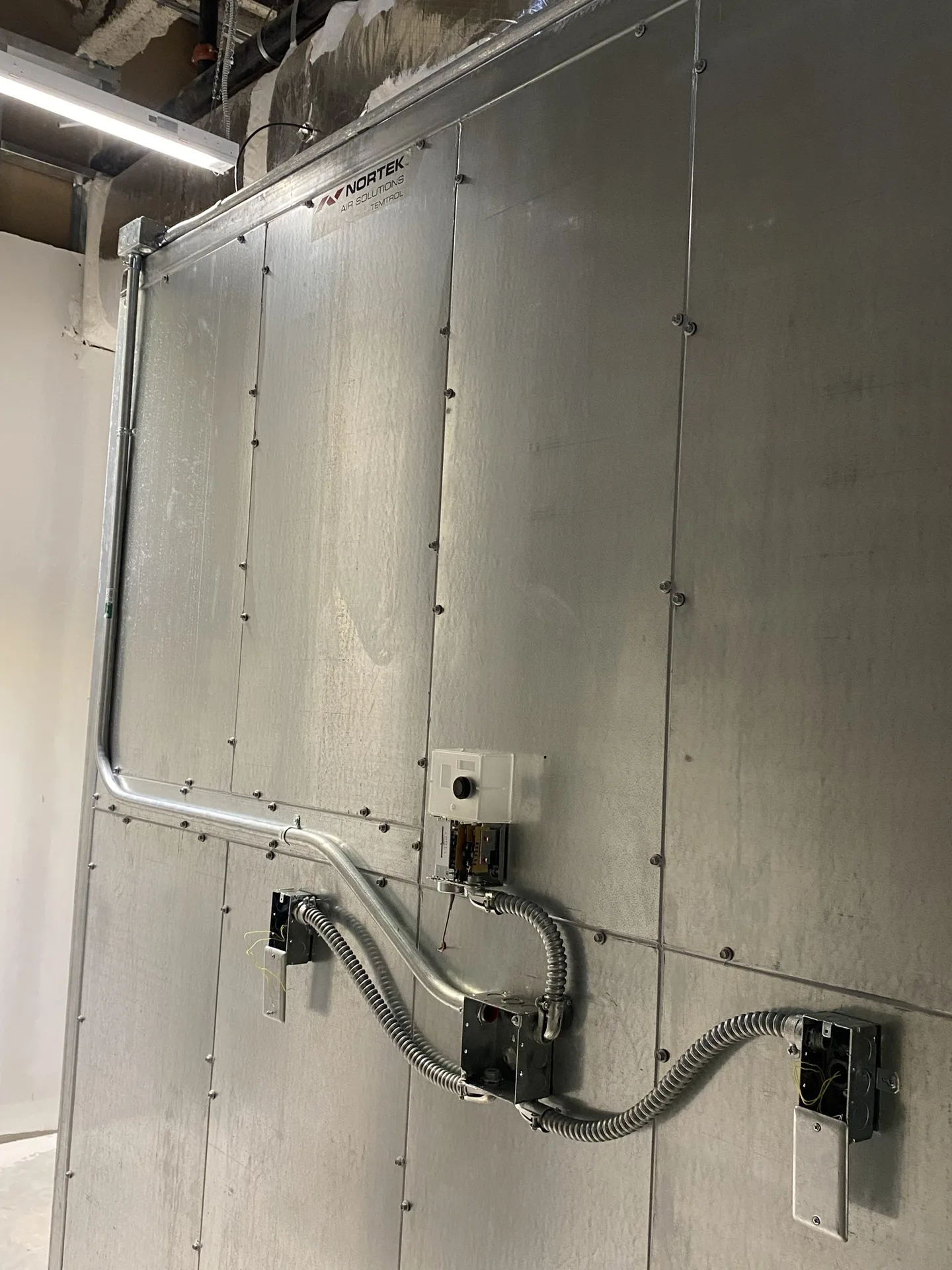 Finished low-voltage equipment installation mounted neatly on a wall.