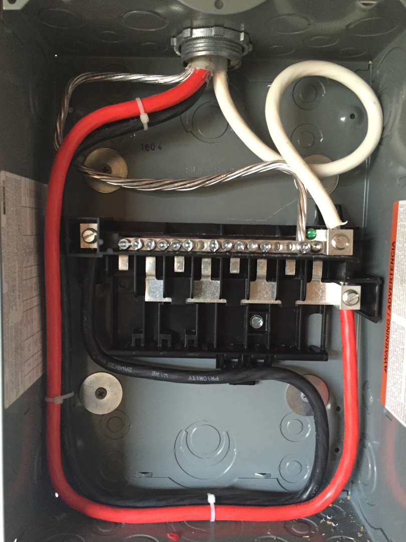 Close-up of electrical panel or disconnect with organized internal wiring.