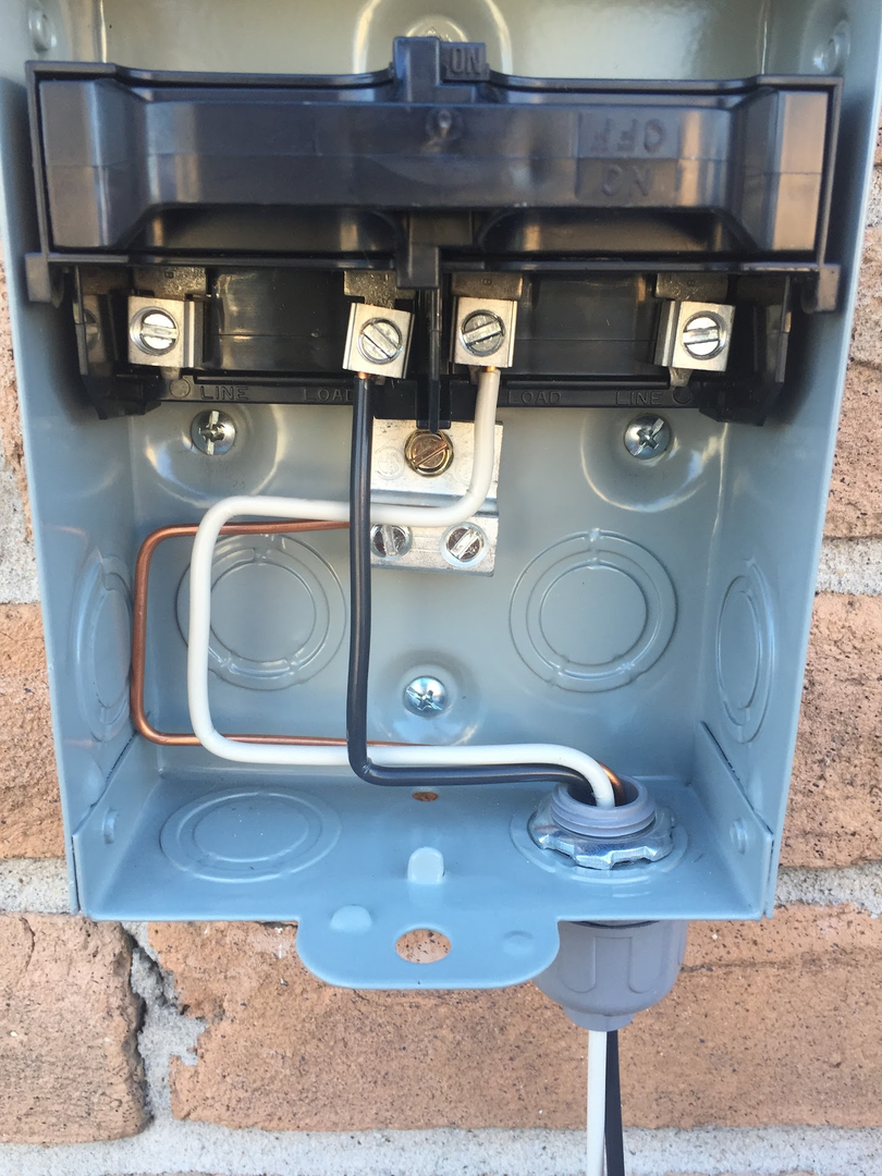 Interior of an electrical disconnect with wiring and terminations visible.