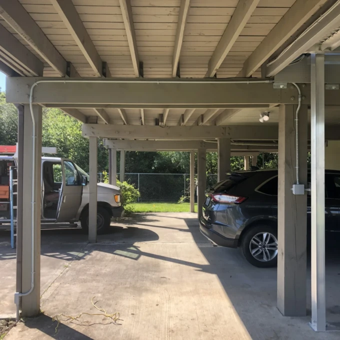 Electrical Work in League City 2 Exterior conduit and lighting installed under a covered parking structure